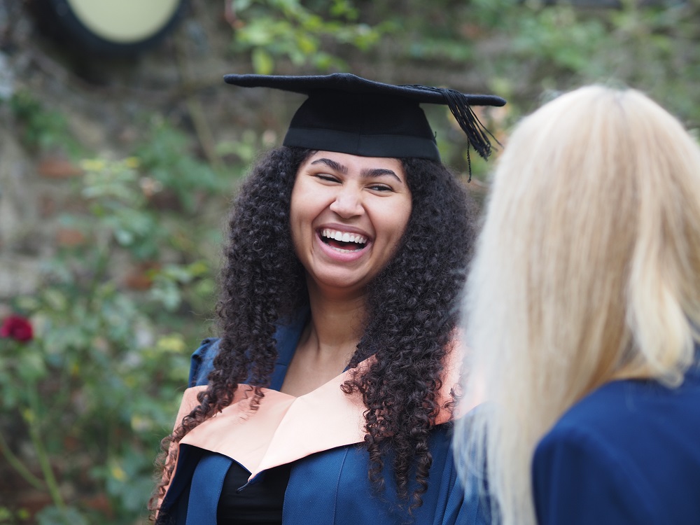 Graduate smiling at Graduation 2024