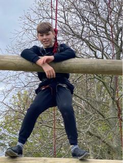 Student from Chalk Hill climbing a frame